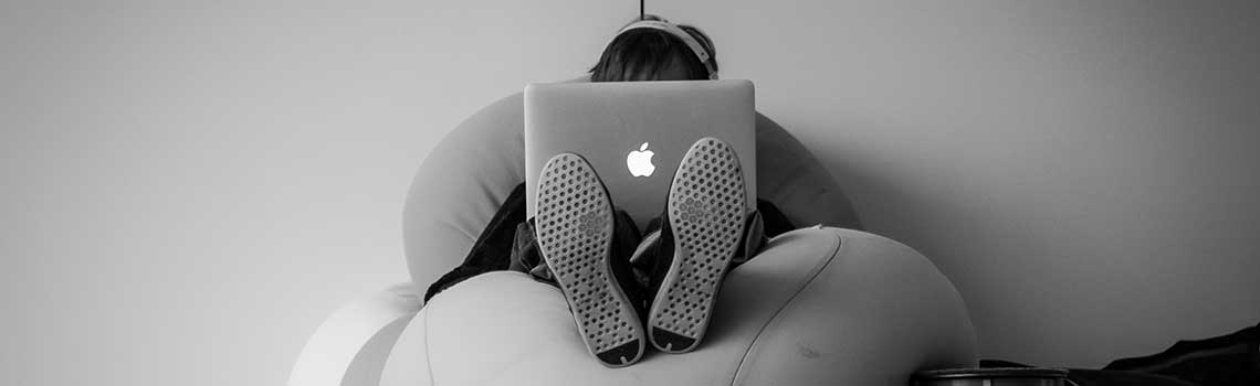 girl on her laptop with headphones on