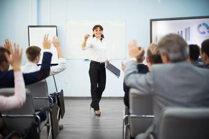 professional training session with the learners raising their hands to ask questions