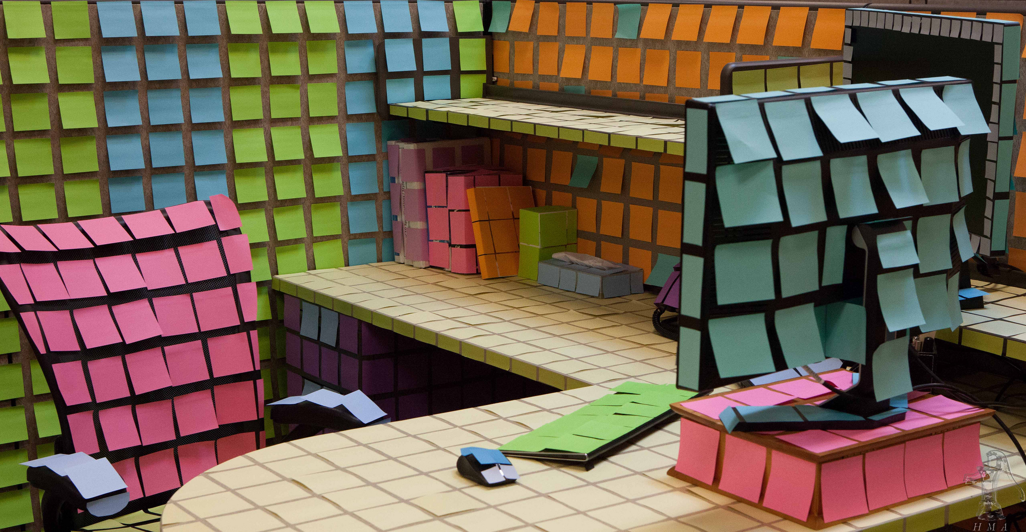 cubicle with post-it notes on every surface