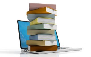 Books stacked on a laptop