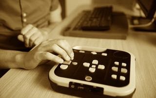 Blind person using audio book player for visually impaired
