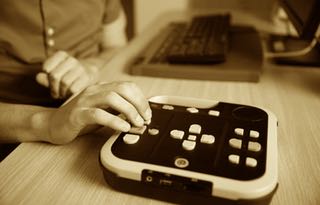 Blind person using audio book player for visually impaired