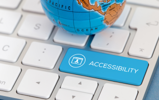 small globe sitting on keyboard with large blue accessibility key