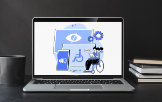 Coffee mug and notebooks sitting next to an open laptop with accessibility icons on it.
